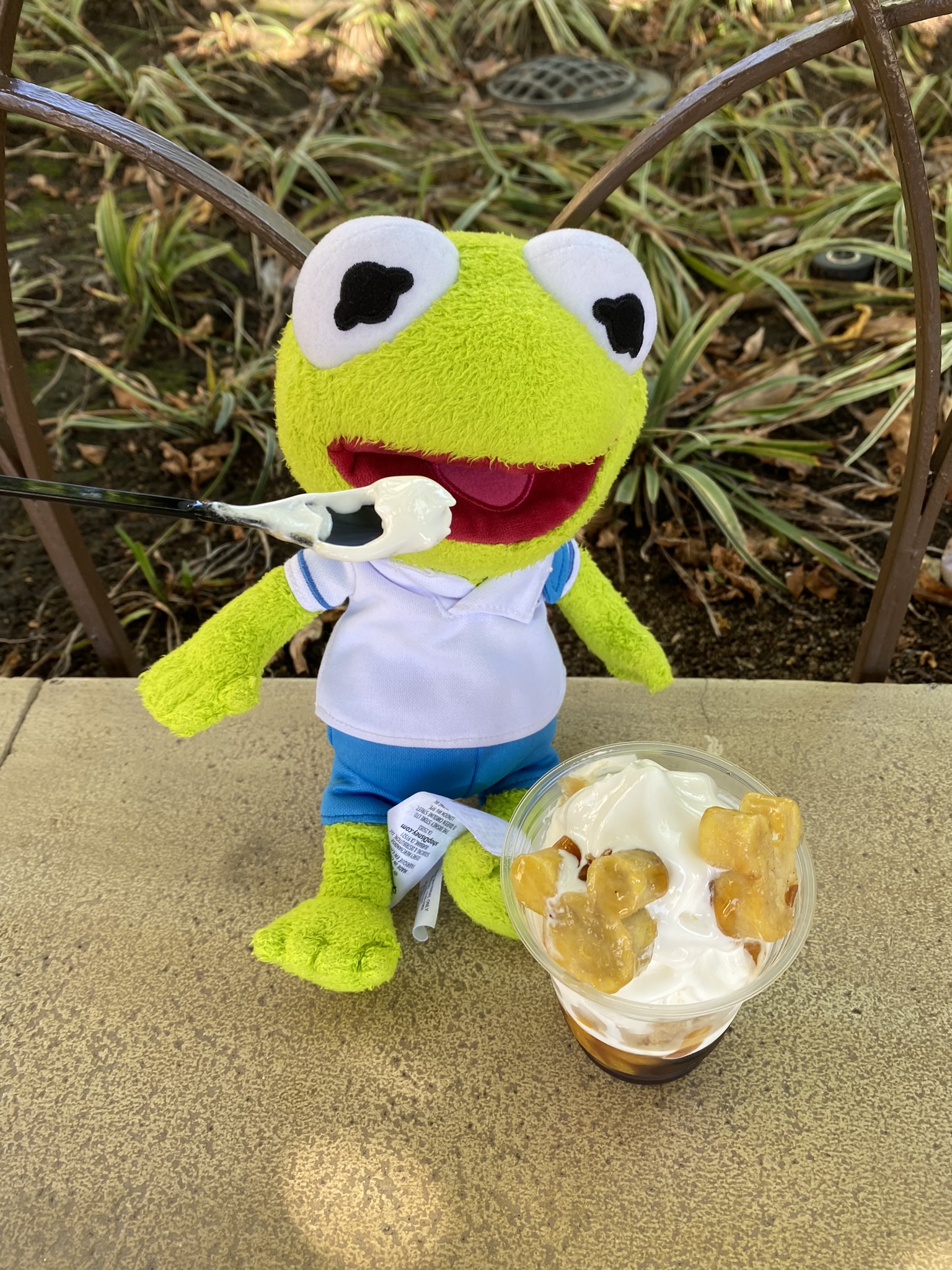 Kermit sitting next to a Sweet Potato Sundae at Disney Sea.