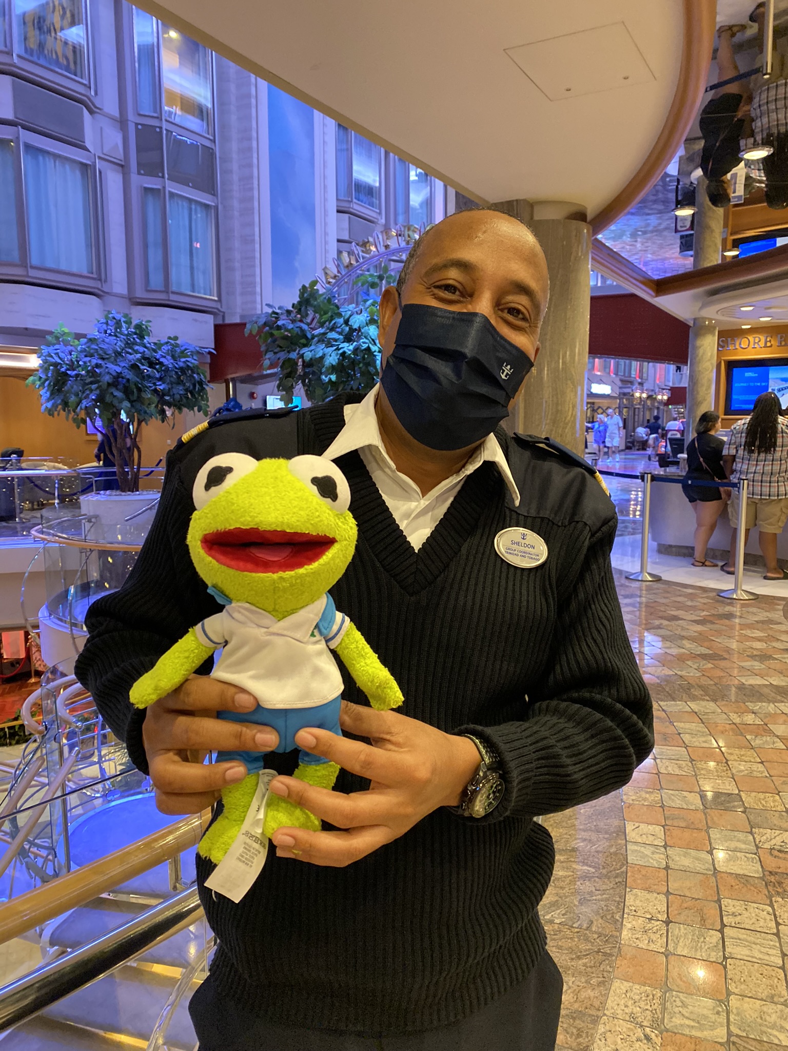 Kermit posing for a picture with Sheldon next to the Guest Services area.